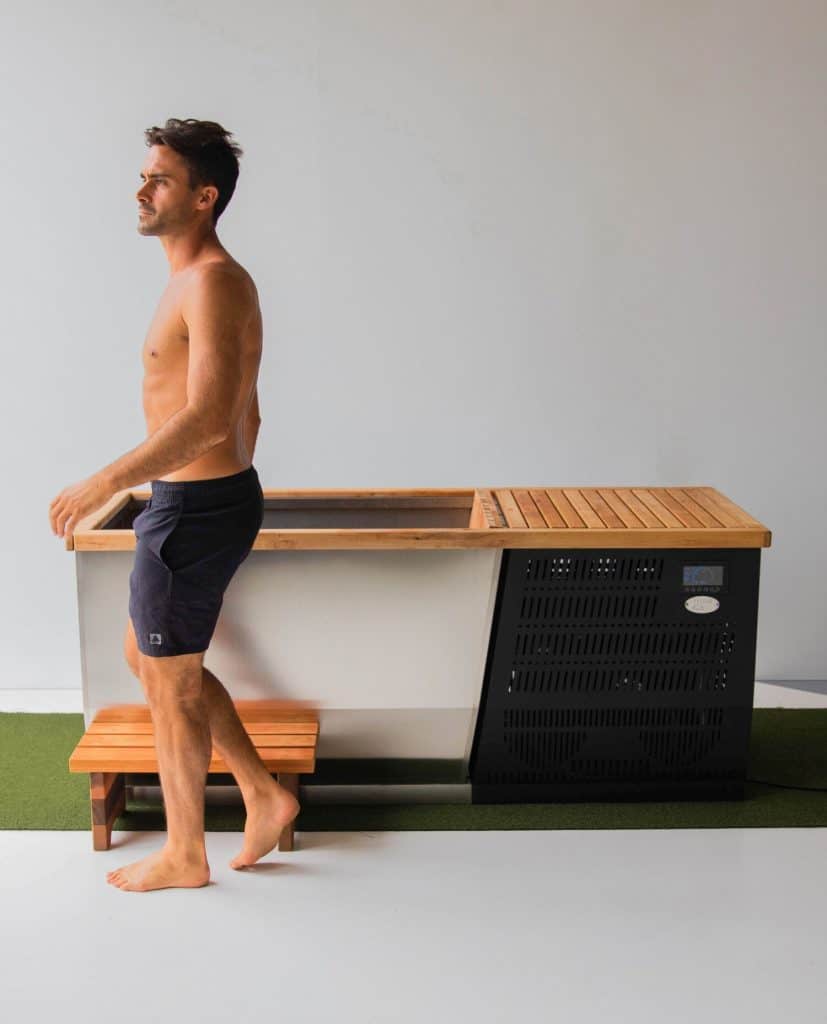 man next to ice bath ready for cold therapy